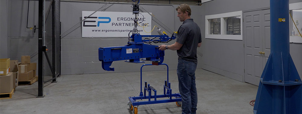 Custom pneumatic gripper tool developed by Ergonomic Partners for for lifting 200 lb electric vehicle batteries.